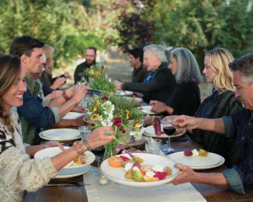 Family eating at a dinner table in the middle of a vineyard in Loudoun County VA
